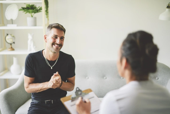A happy man talking with his therapist during a counseling session